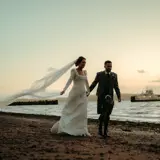 couple walking on beach at brisbane house largs wedding venue